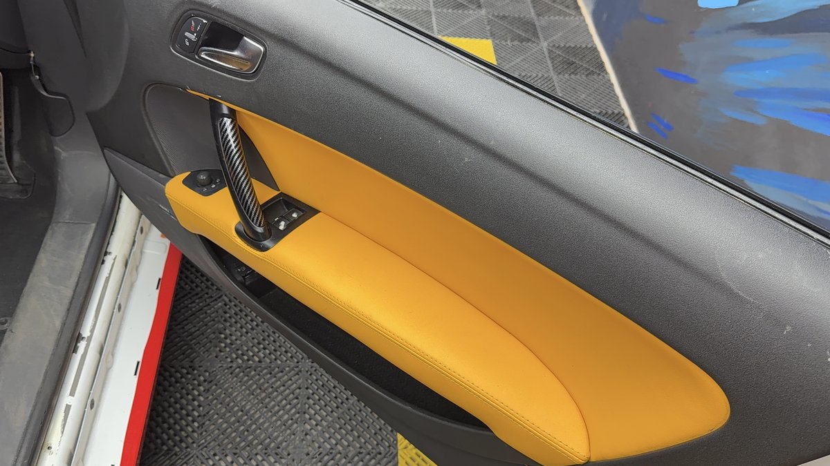 Audi TT receiving precision high-gloss paint protection film in studio